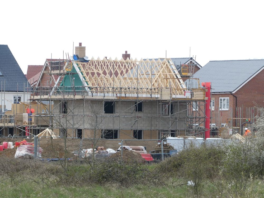 Roof trusses going up on a double-storey house